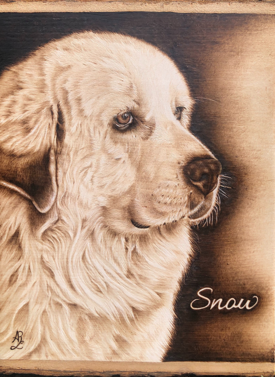 Wood-burning of a Great Pyrenees with light fur, looking to the right. The background features a gradient from dark to light. The word 'Snow' is written in cursive at the bottom right corner.