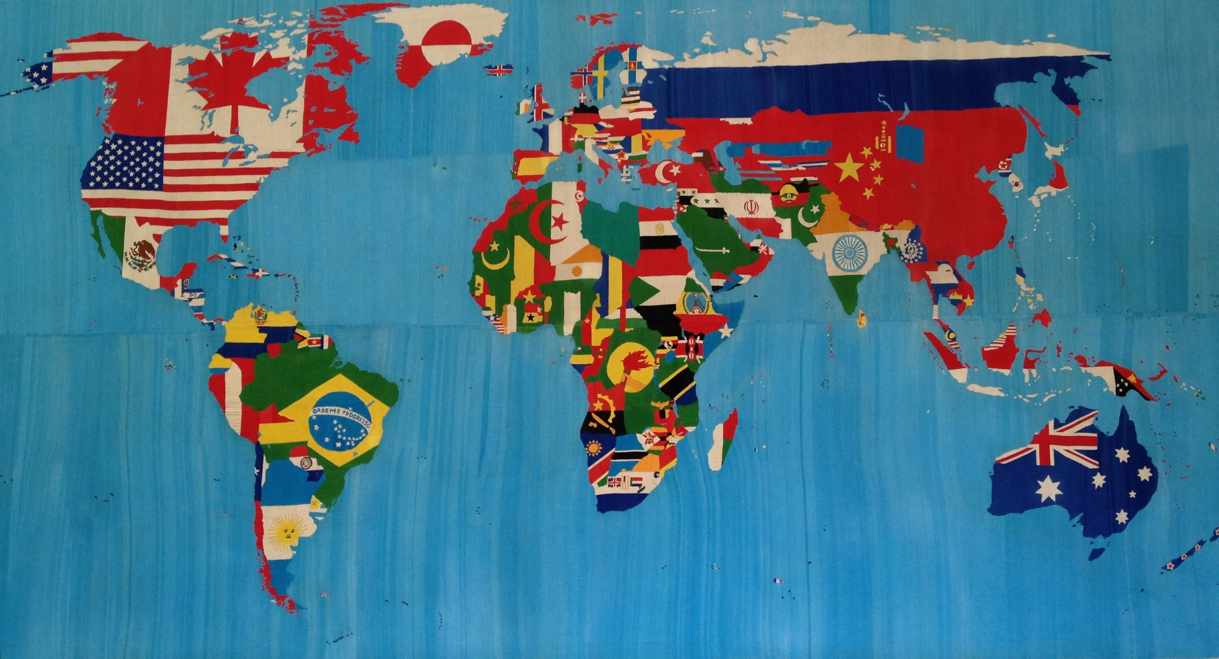 A landscape with multiple wind turbines in a desert area under a blue sky with scattered clouds.