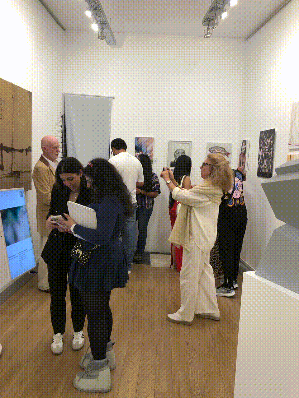 Visitors viewing artworks at Arrival Gallery’s Paris exhibition