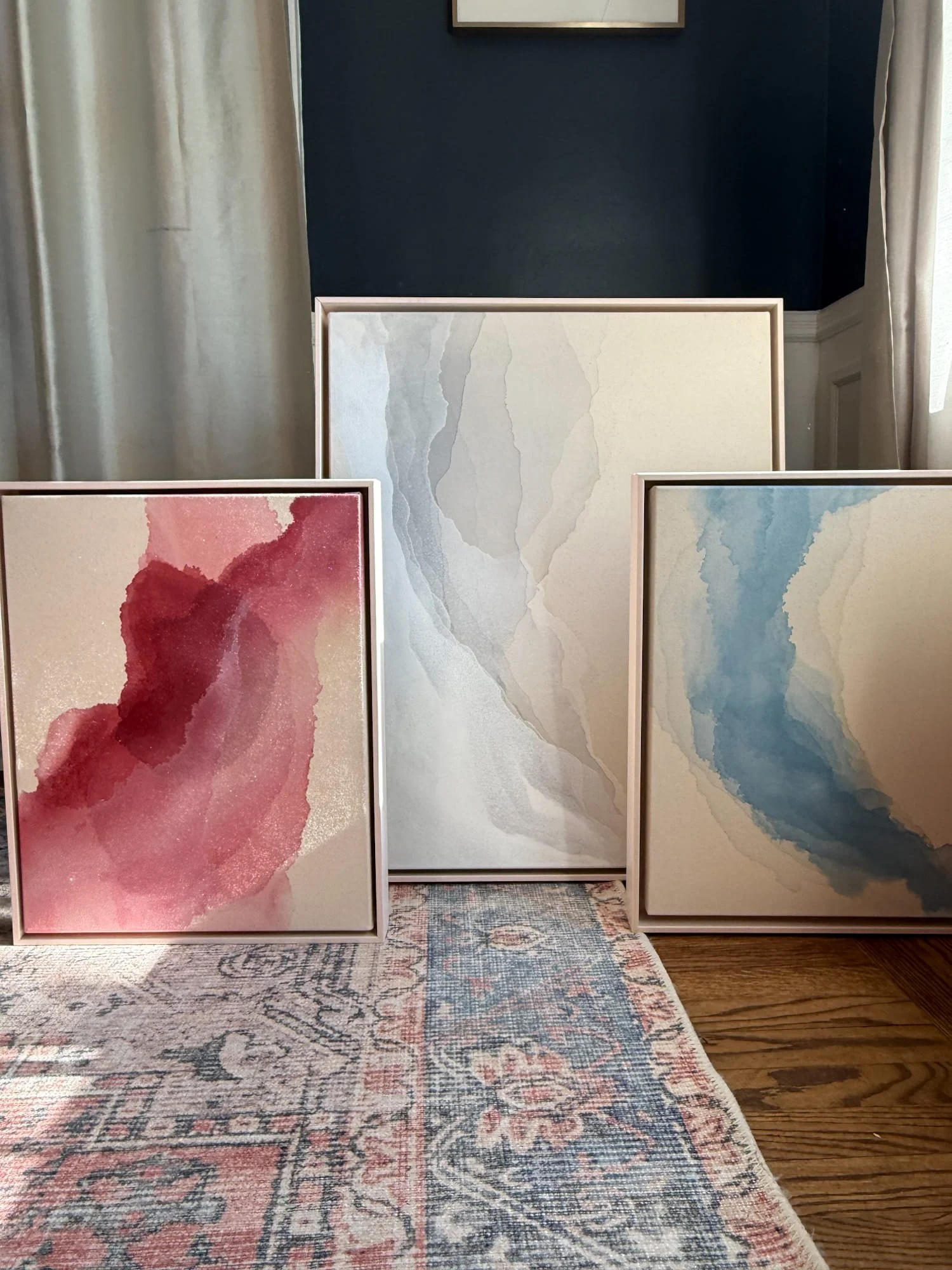 Whispering Tides Collection: three abstract acrylic paintings in soft gradients of red, blue, and neutral tones, evoking quiet movement and emotional clarity