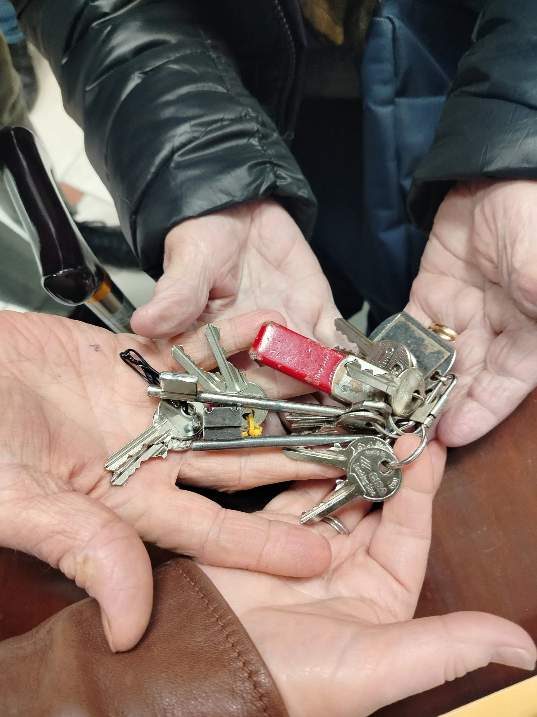 Official property key handover after completing a home purchase in Le Marche.
