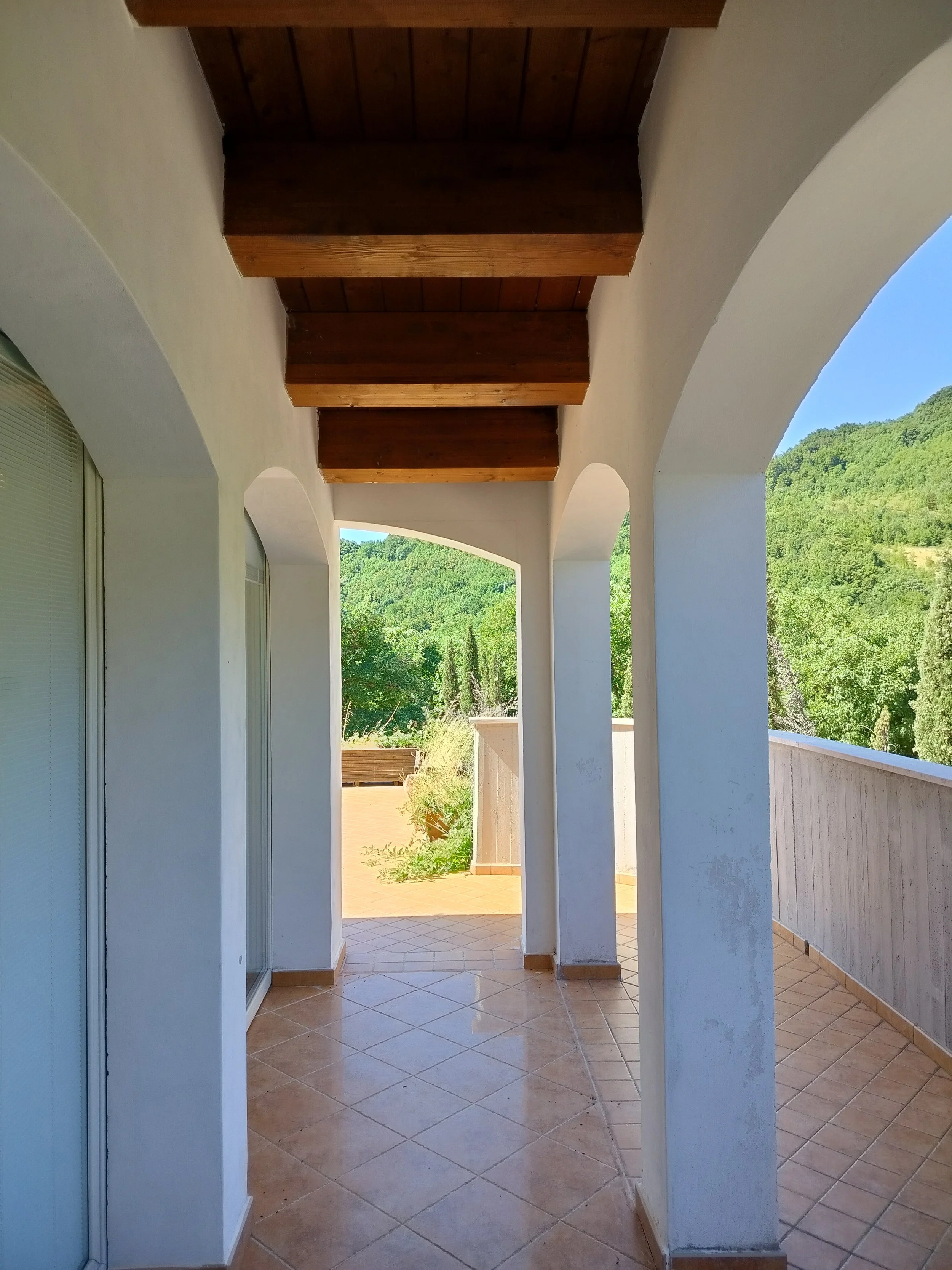 Covered outdoor terrace of an Italian country house in Le Marche.