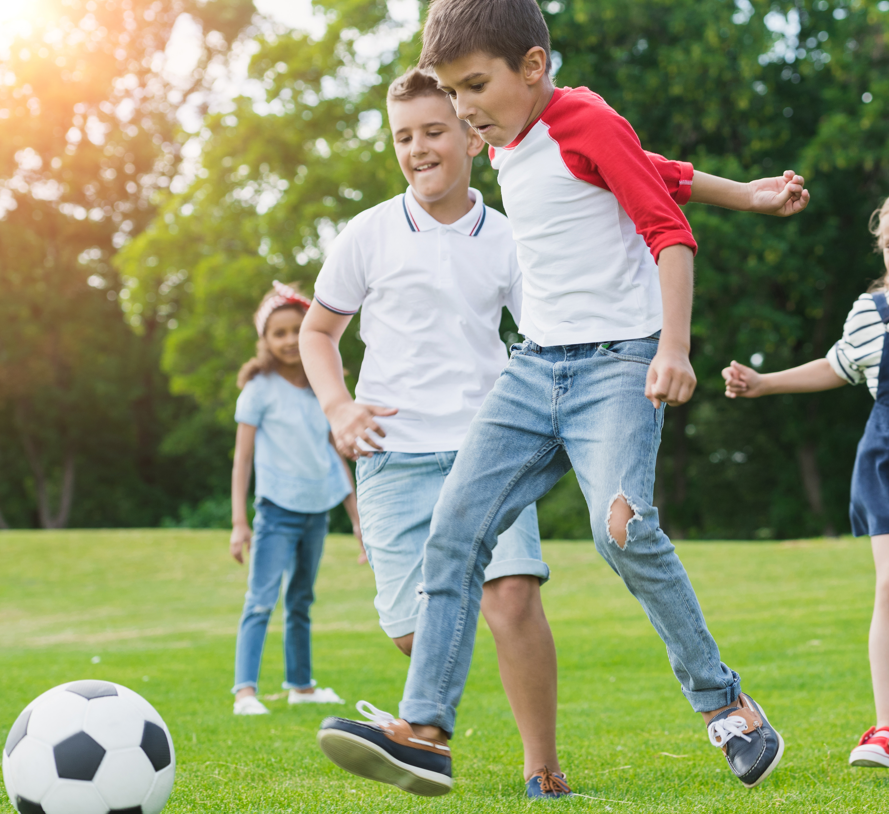 Children from Blossoms Childcare playing football at meadowbrook pitches in Dundrum