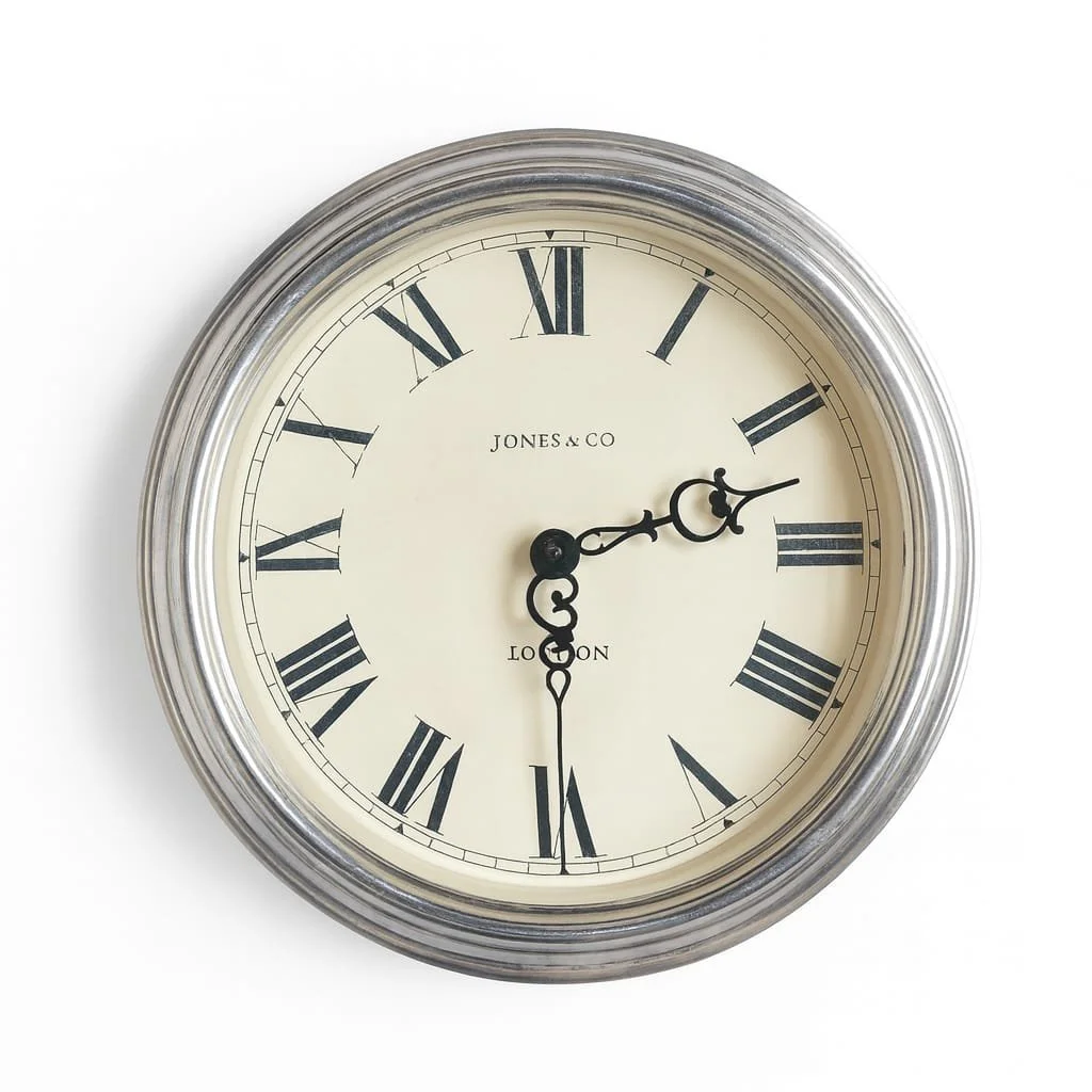 A round wall clock with a silver frame, white face, black Roman numerals, and black ornate hands, showing the time as 2:30. We do 2.30 pick ups