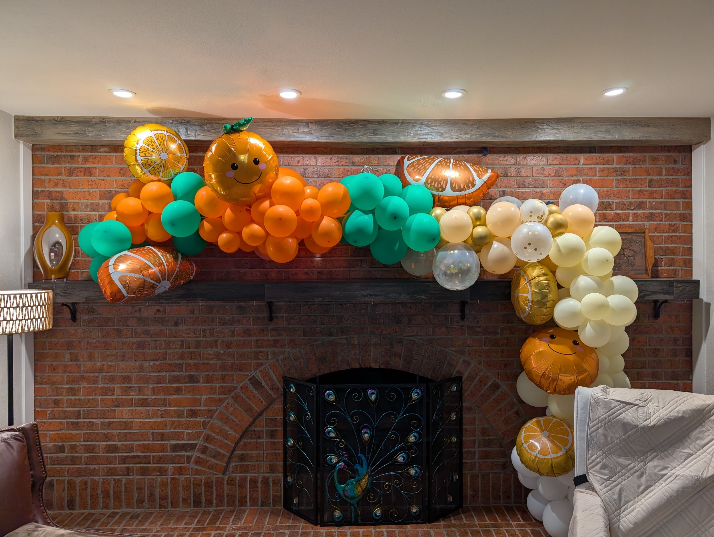 orange green and gold balloon garland with cutie theme