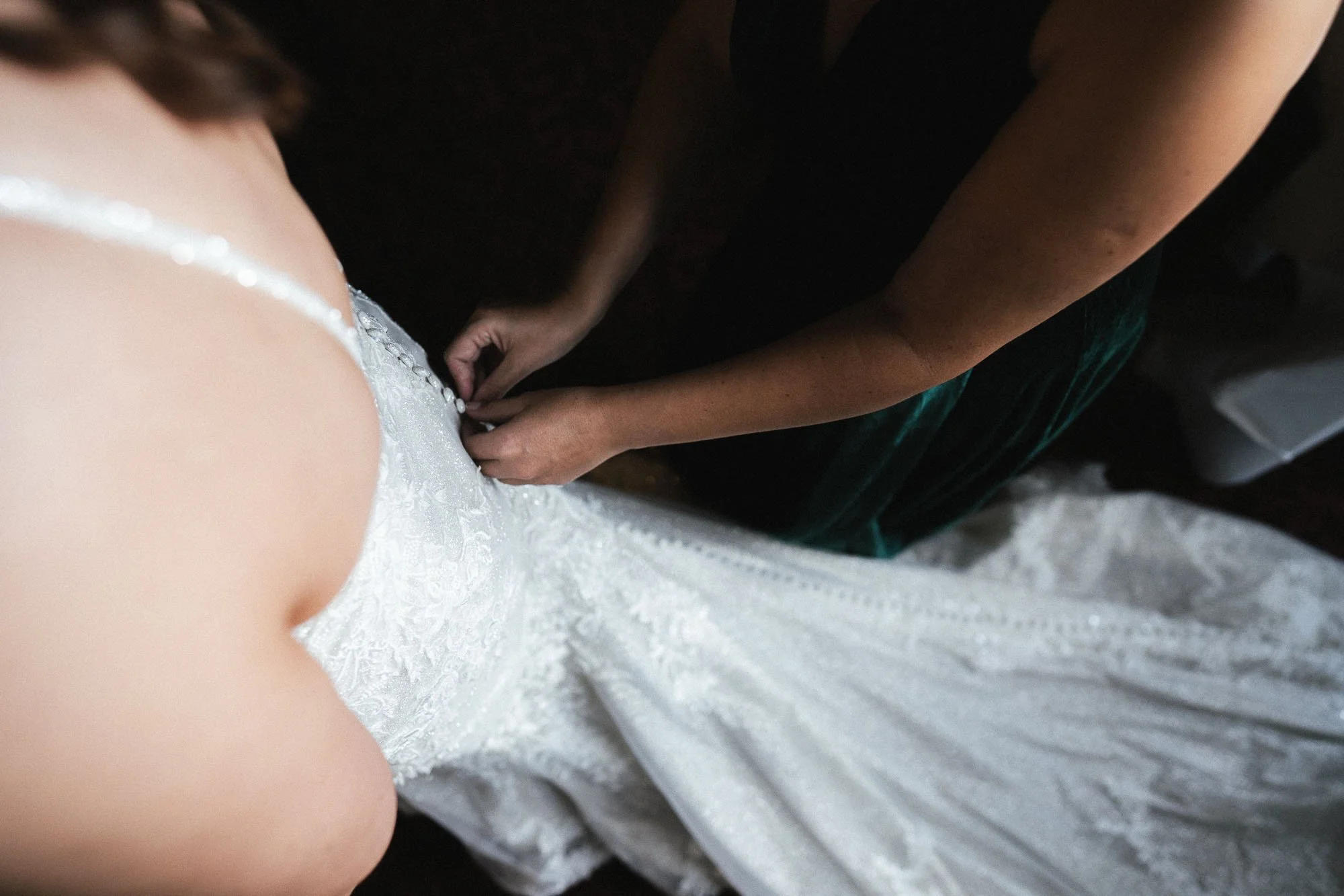 bottoning-up-bride's-dress-wedding-photography.jpg
