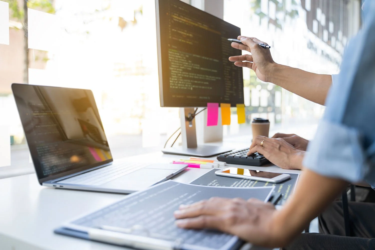 Software engineering consultant Arthur Goldberg reviewing source code and infrastructure with a client in a technical consulting session.