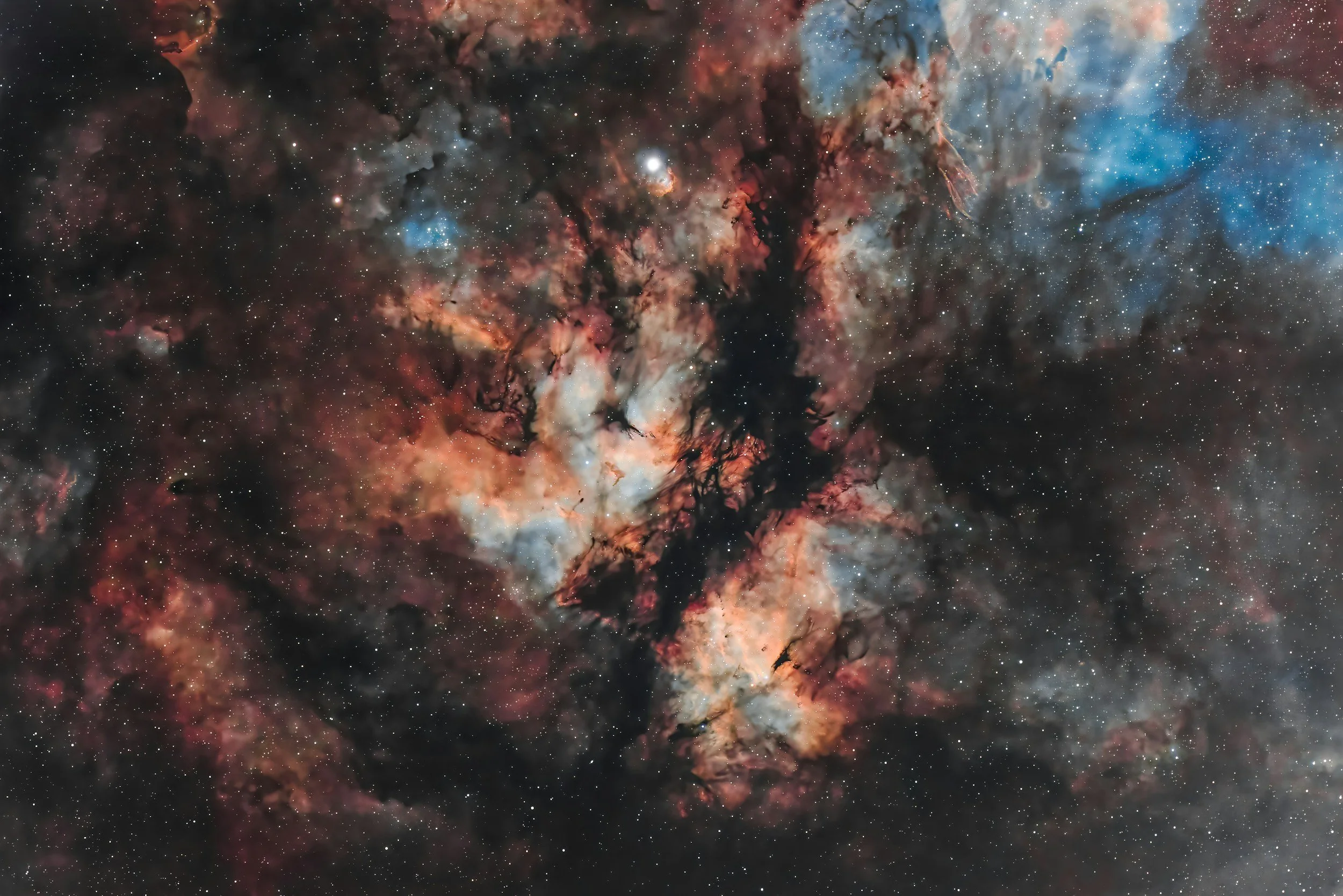 A colorful image of a nebula in outer space with stars and cosmic dust.