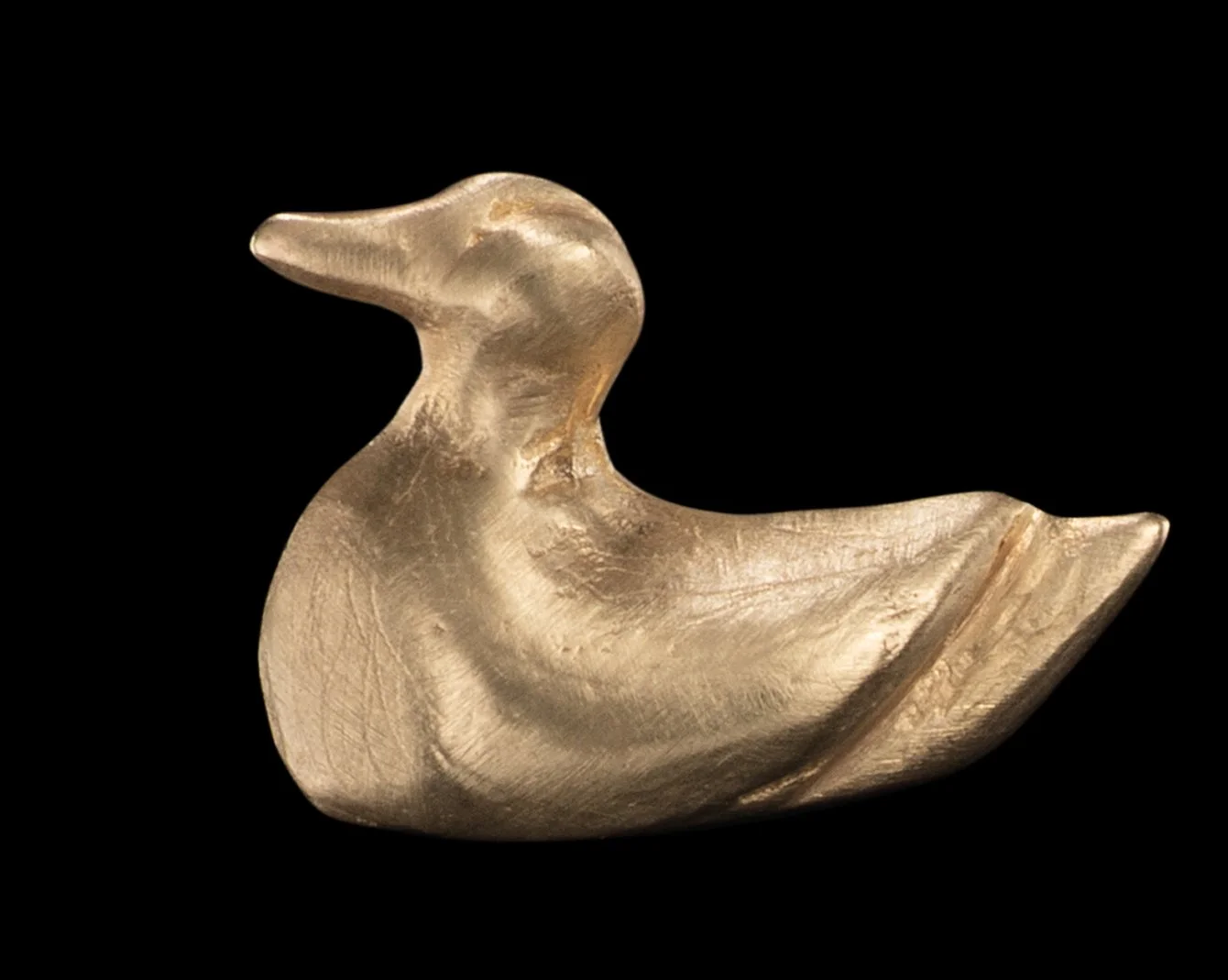 A gold stud earring in the shape of a duck by Alexandra Cordon jewellery
