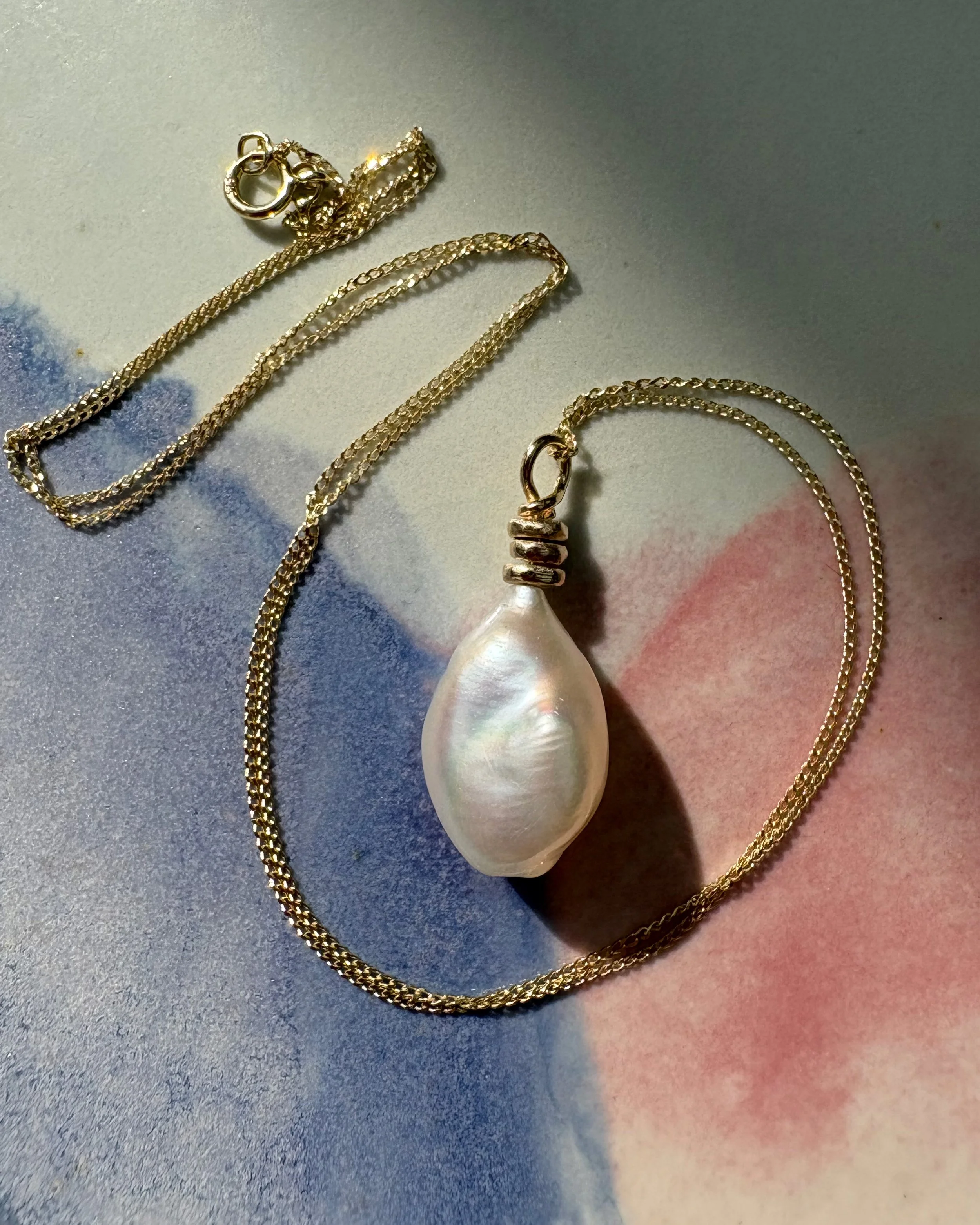 Vessel shaped keshi on 9ct gold Abacus pendant.jpg