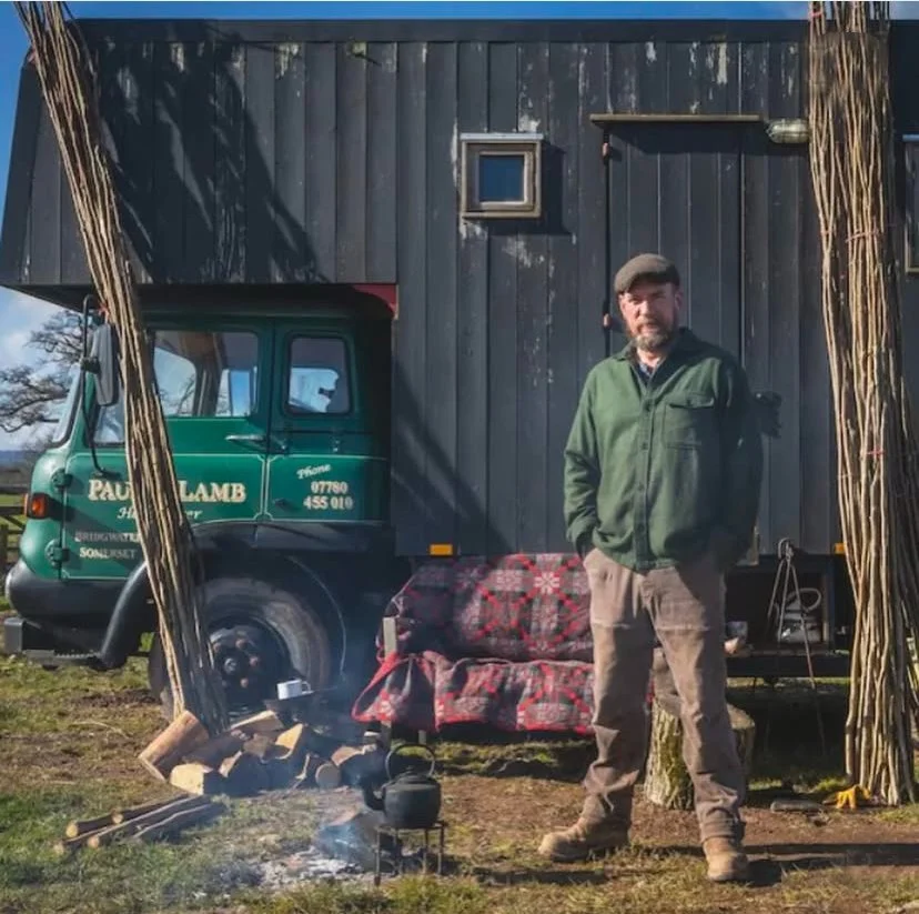 Paul standing in front of his old wagon