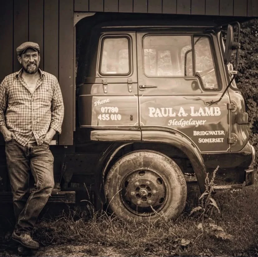 Paul standing in front of his old wagon