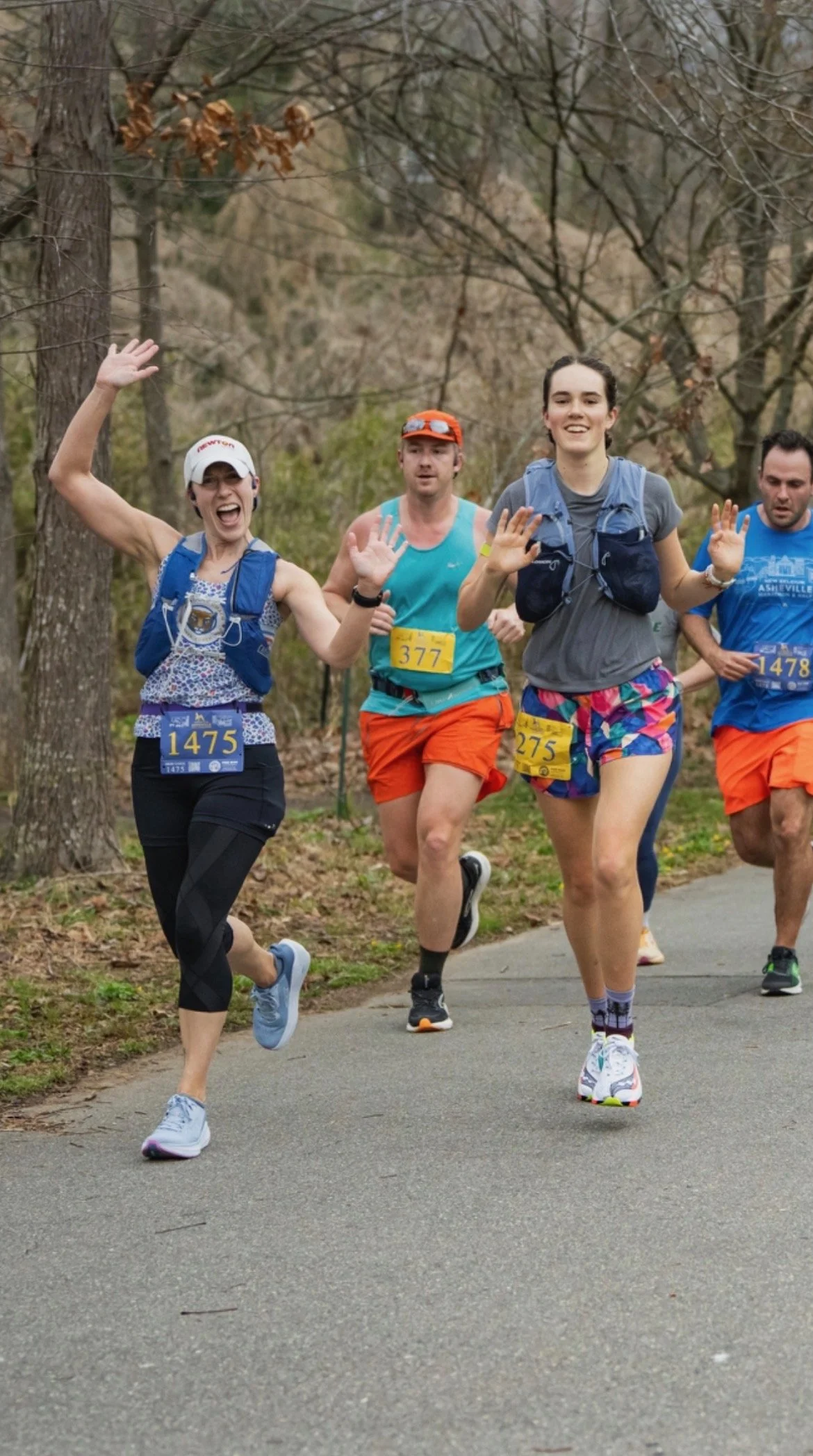 asheville half marathon, runner with arms open smiling, rogue run tank top