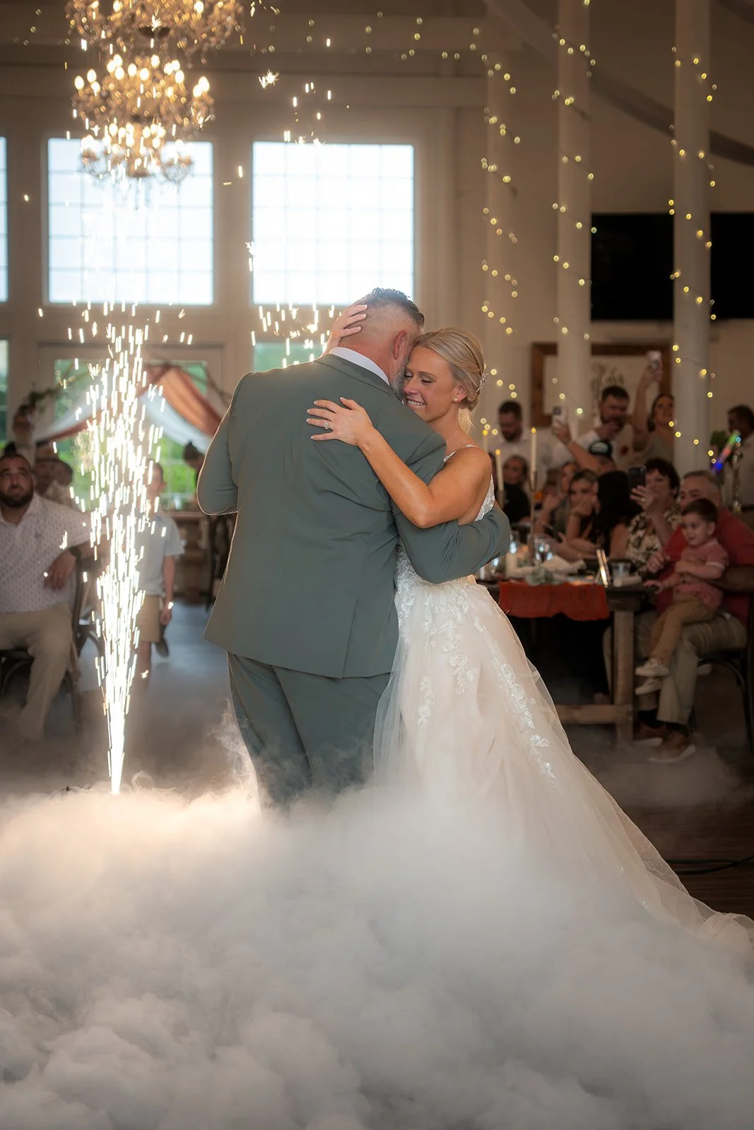 Tiffany and Matthew share their first dance with cold sparks at their Ever After Farms Citrus Barn wedding in Polk City, Florida.