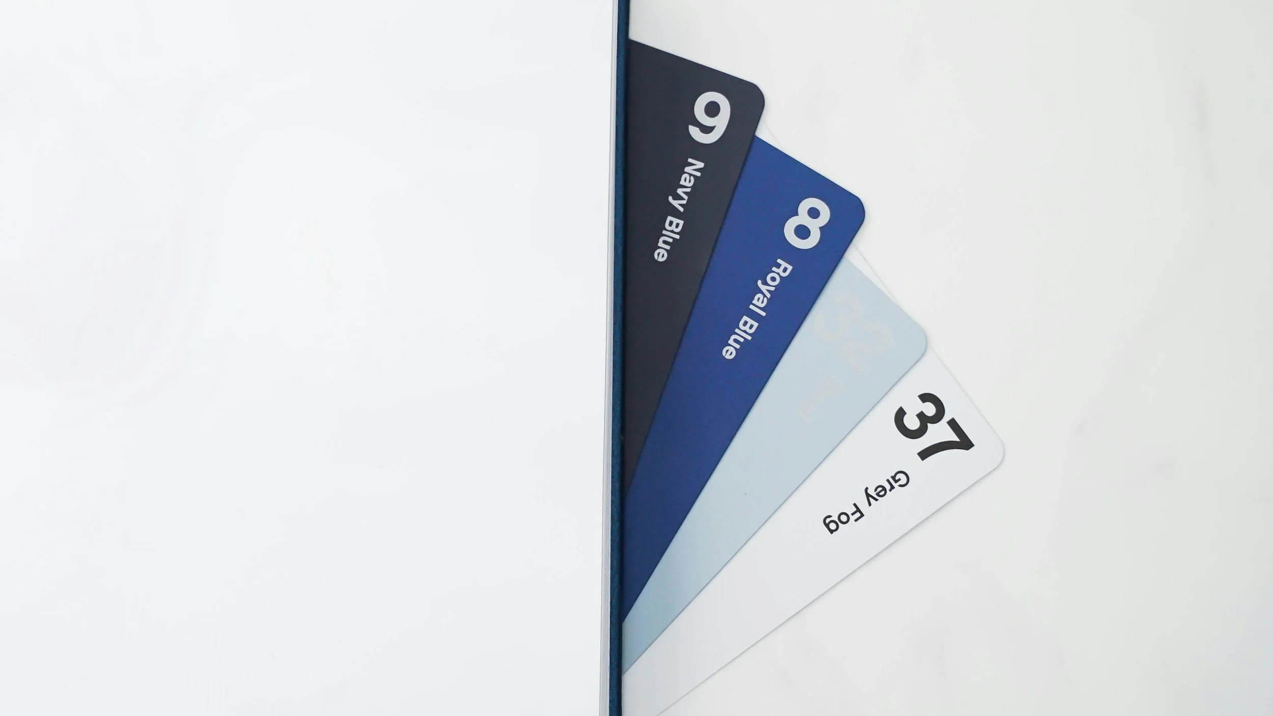 Color sample cards labeled Navy Blue, Royal Blue, and Grey Fog arranged in a fan shape.