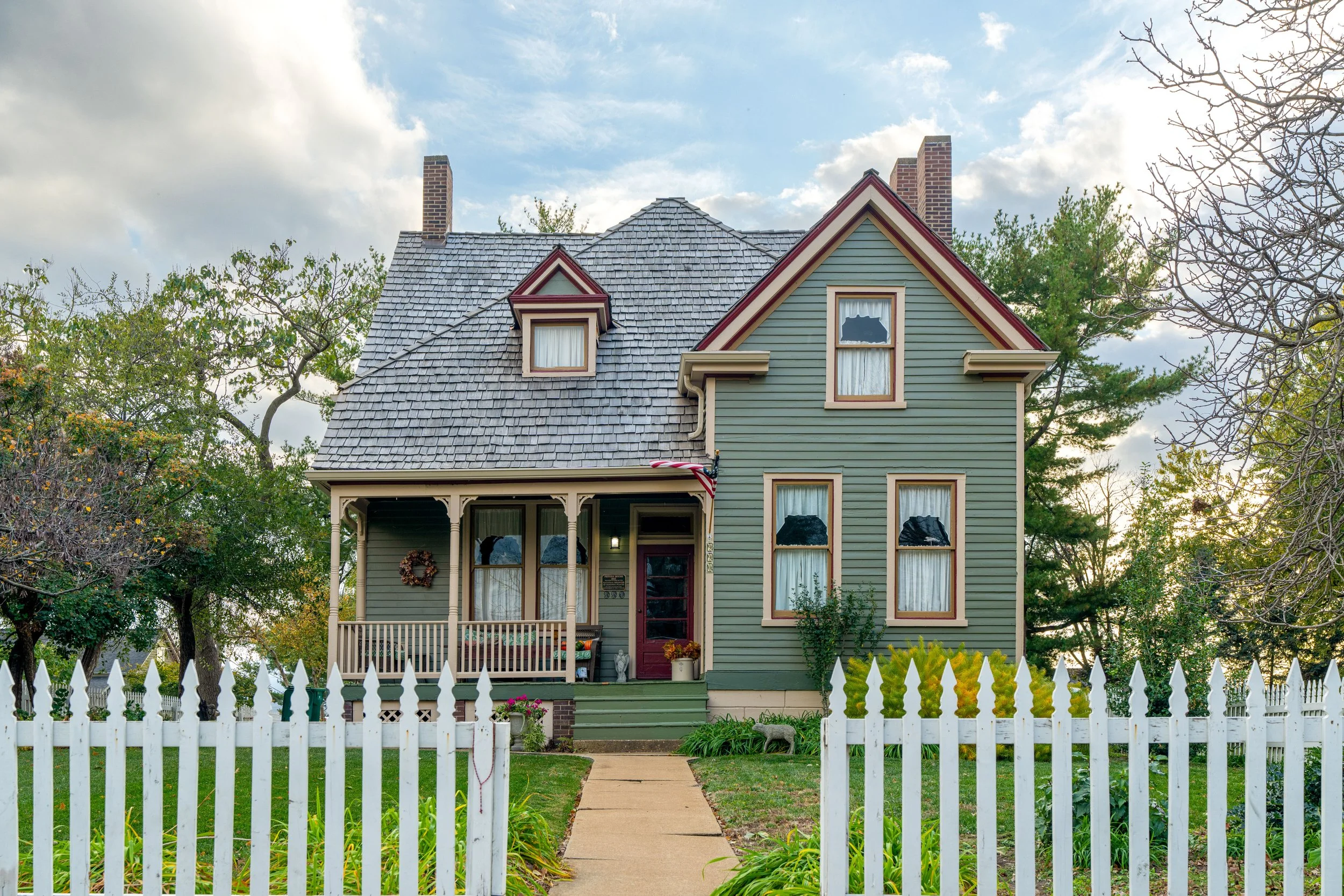 Charming historic home with white picket fence representing St Louis area real estate