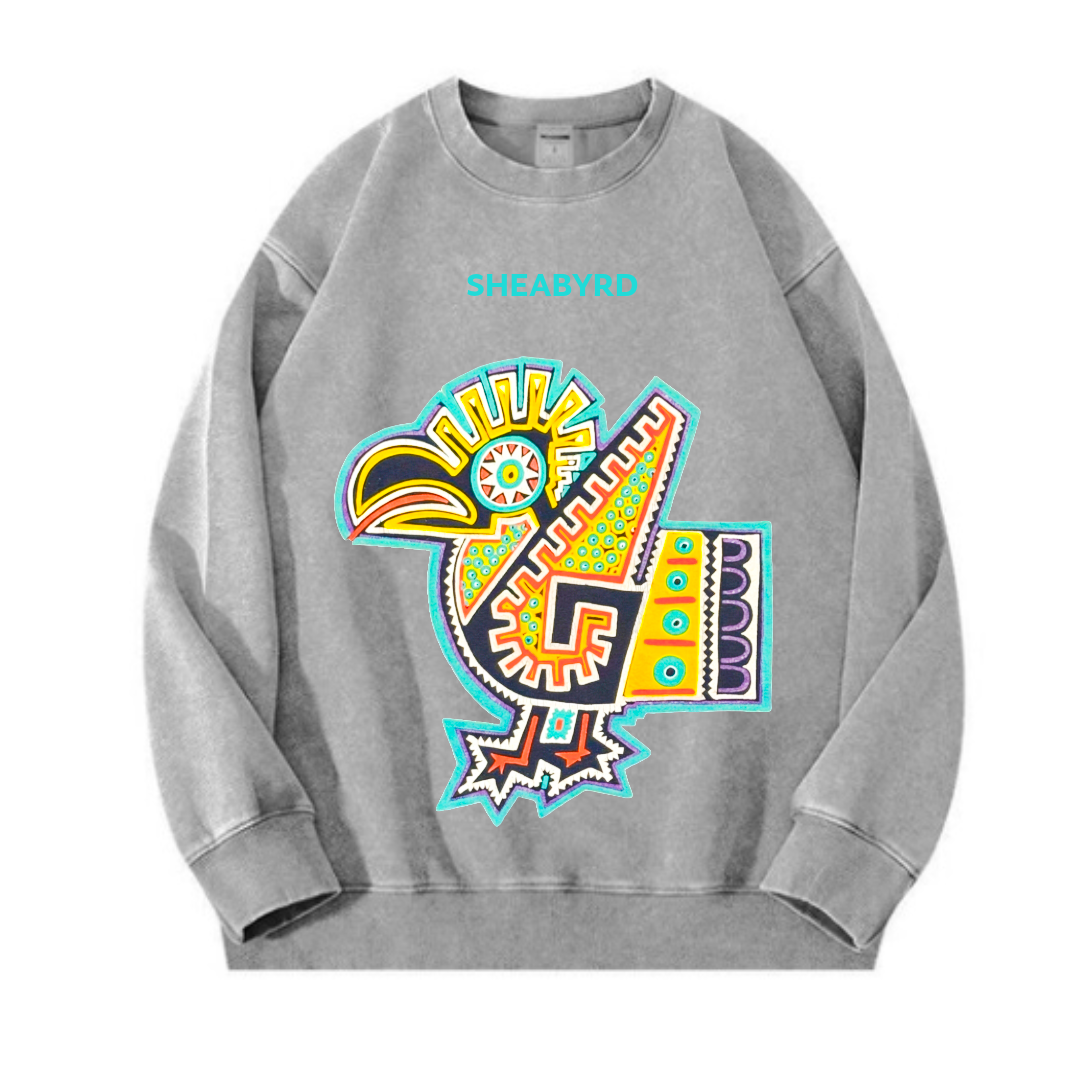 Gray sweatshirt featuring a colorful, abstract bird design and the text 'SHEABYRD' on the chest.