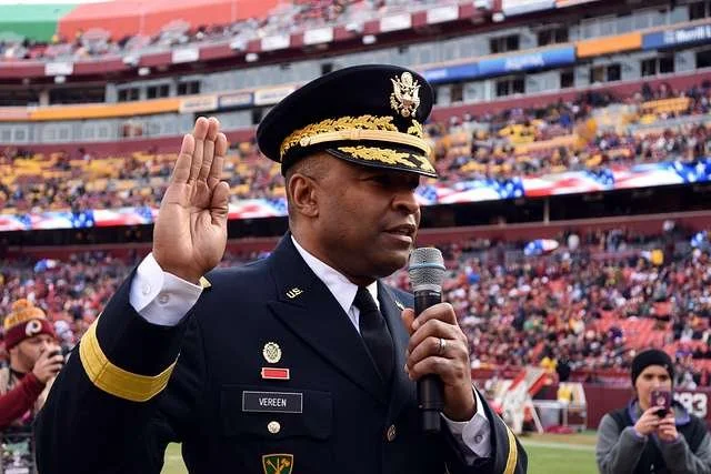 Brig. Gen. Kevin Vereen, deputy commanding general operations for U.S. Army Recruiting Command, gives the oath of enlistment to nearly 100 Future Soldiers during halftime of the Washington's Salute to Service game in 2017.