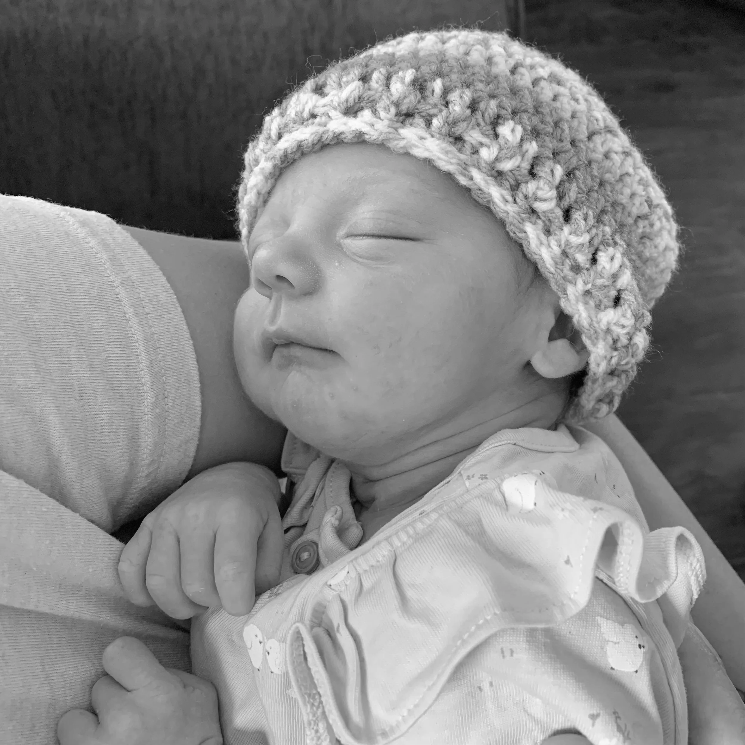 Newborn sleeping in mother's arms
