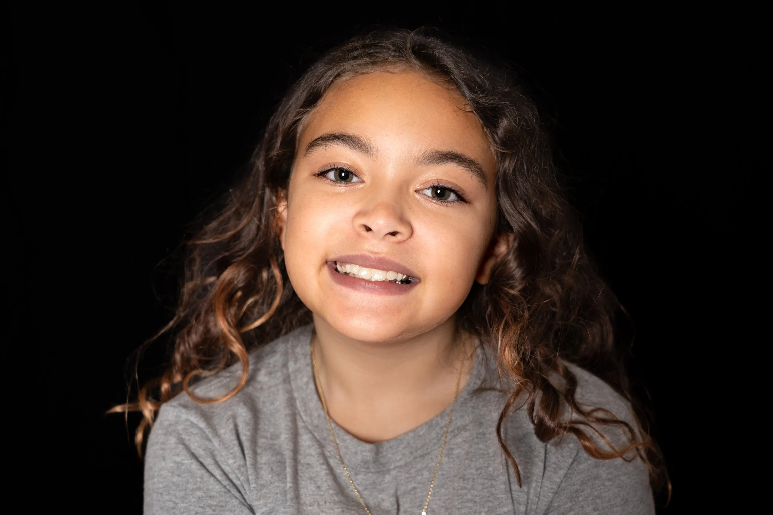 A relaxed school portrait highlighting a genuine expression