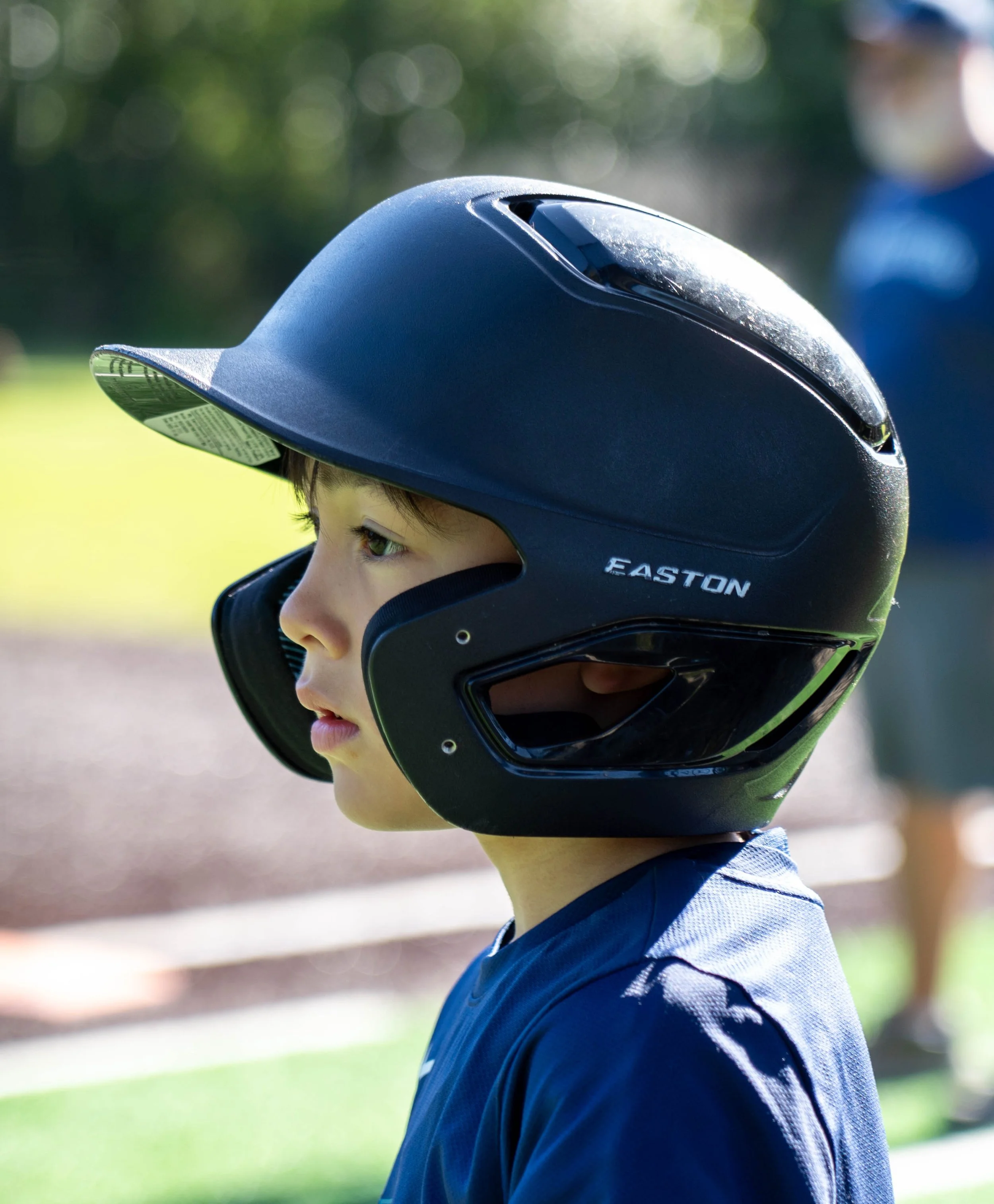 Youth baseball player wearing a batting helmet during an outdoor game in Mercer Island, Washington.