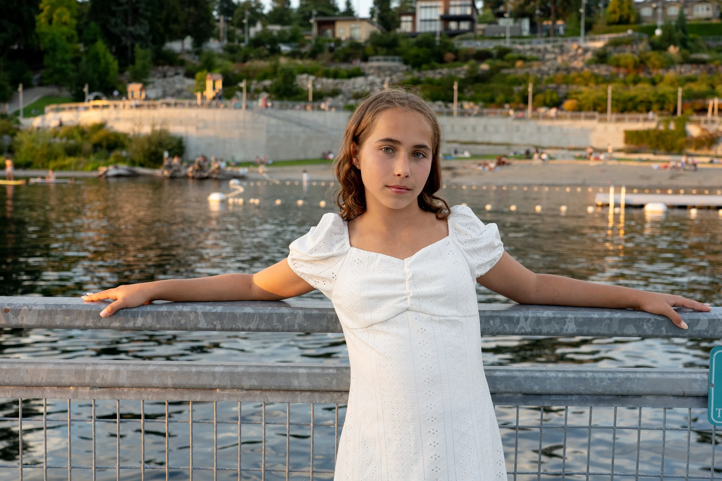Golden hour portrait of a young girl overlooking the Mercer Island waterfront. Outdoor sessions allow children to relax, explore, and show their personalities, creating authentic family photographs full of warmth and connection.
