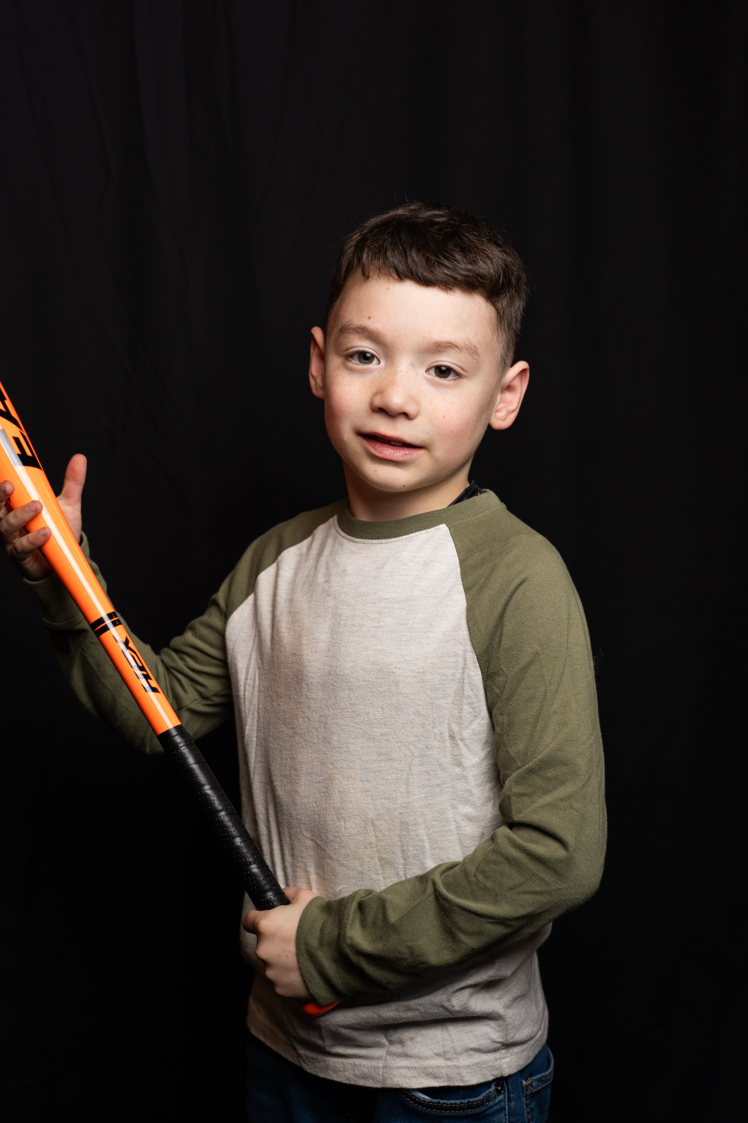 youth-baseball-portrait-boy-with-bat-studio-black-background.jpg