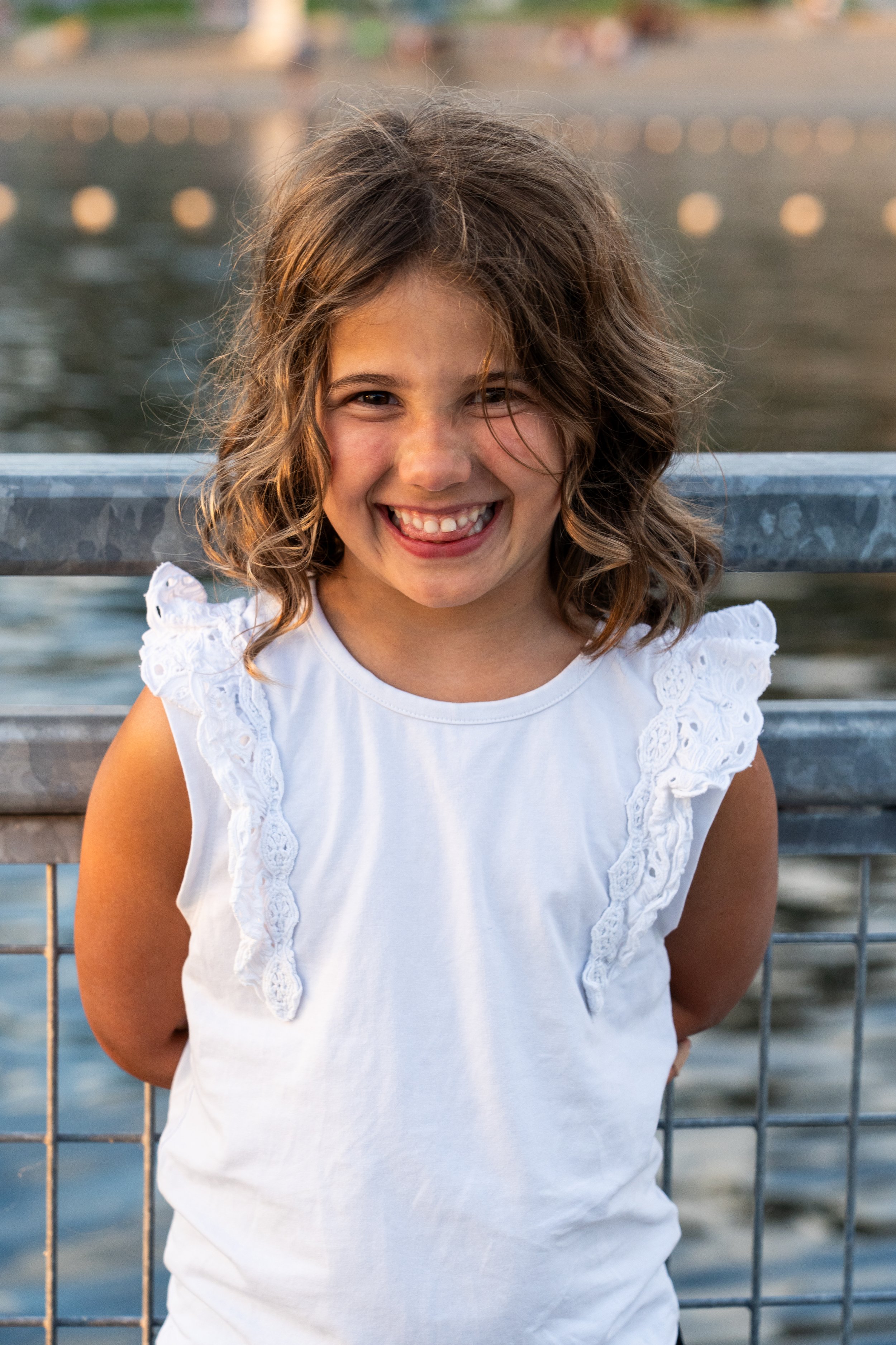 A joyful portrait of a young girl captured during a relaxed family photography session on the Mercer Island waterfront. Natural smiles and genuine expressions create timeless images that families treasure for years.
