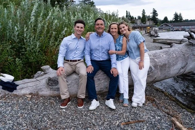A relaxed waterfront family portrait at Meydenbauer Bay Park, capturing authentic connection and natural moments in Bellevue, Washington.