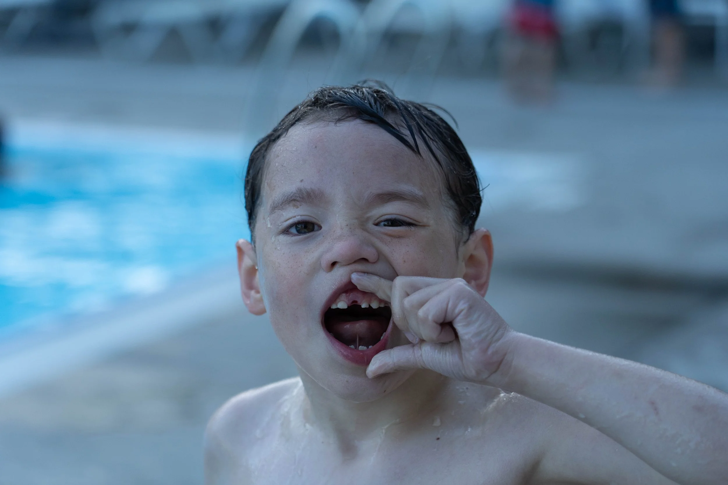 boy-missing-tooth-pool-photo-candid-seattle.jpg
