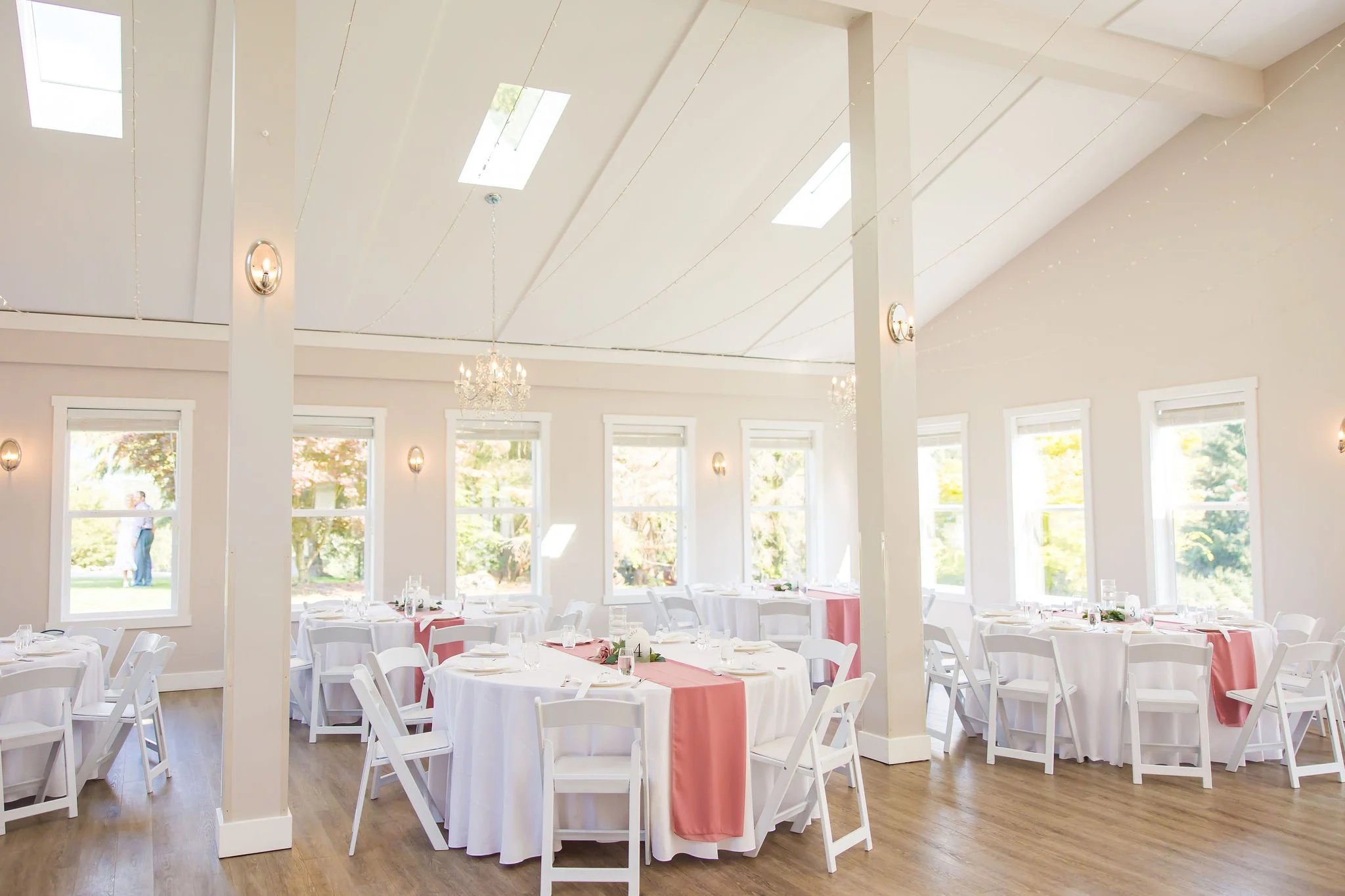 The bright and airy reception space set with round dining tables