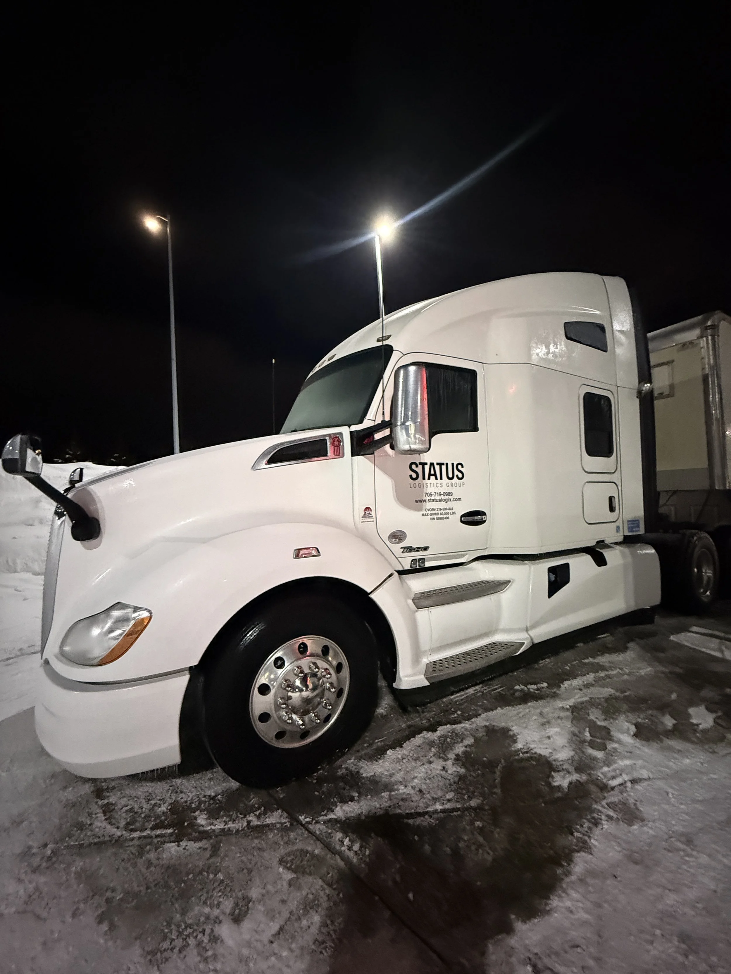 White Freight-liner truck, after getting washed. 