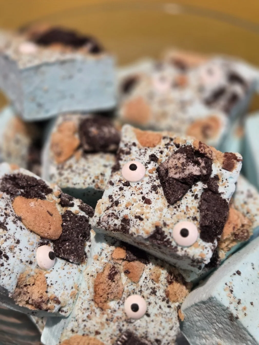 Monster marshmallow: vanilla flavored marshmallow with chopped cookies and candy eyeballs scattered on top