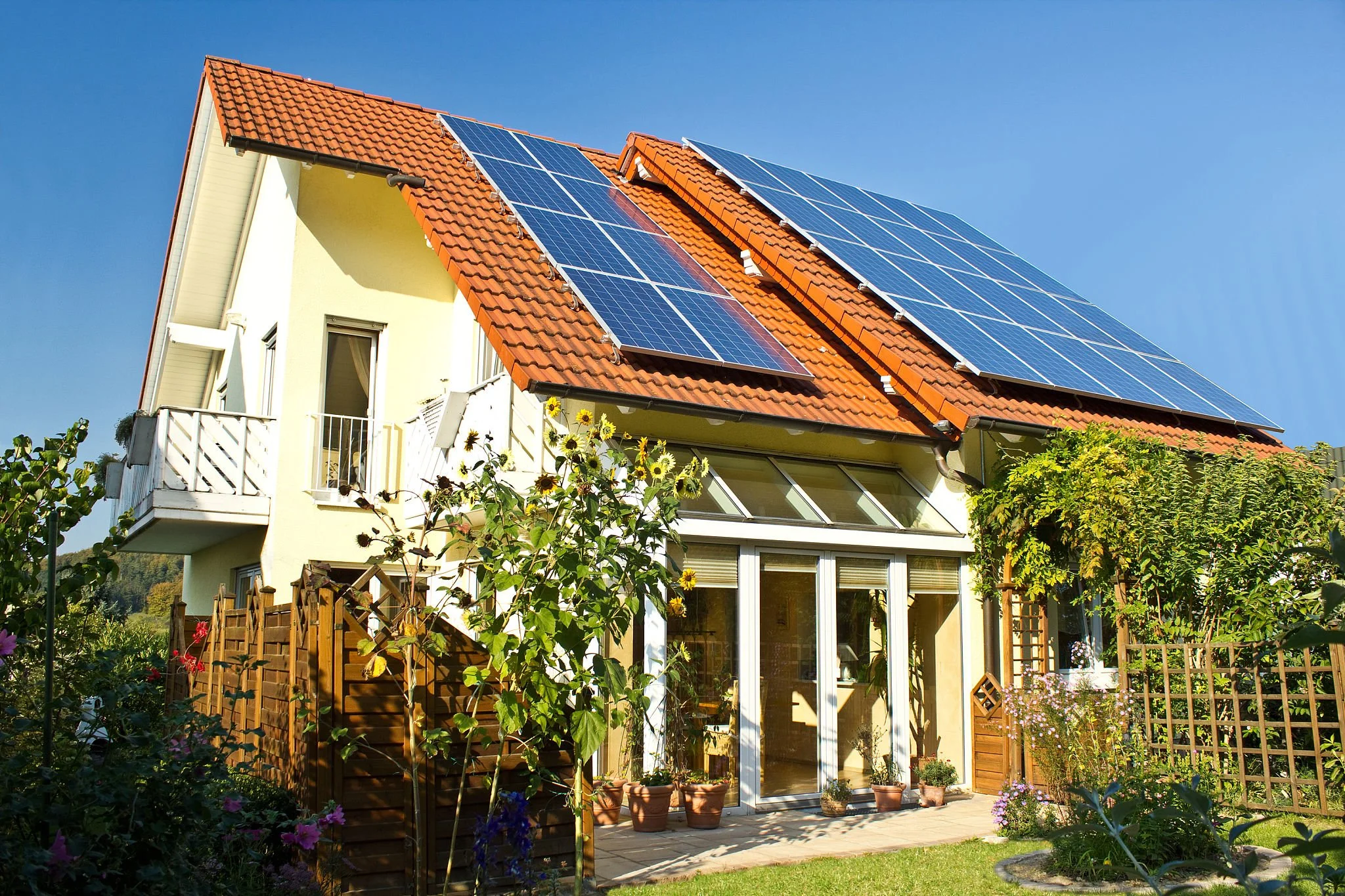 Solar panels on roof of house in late summer.jpg