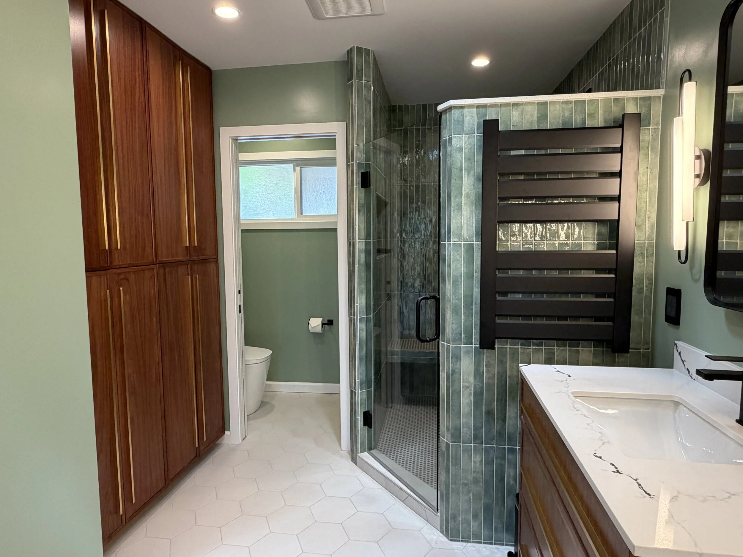 Primary Bathroom Renovation with Walnut Cabinets and Black hardaware throughout