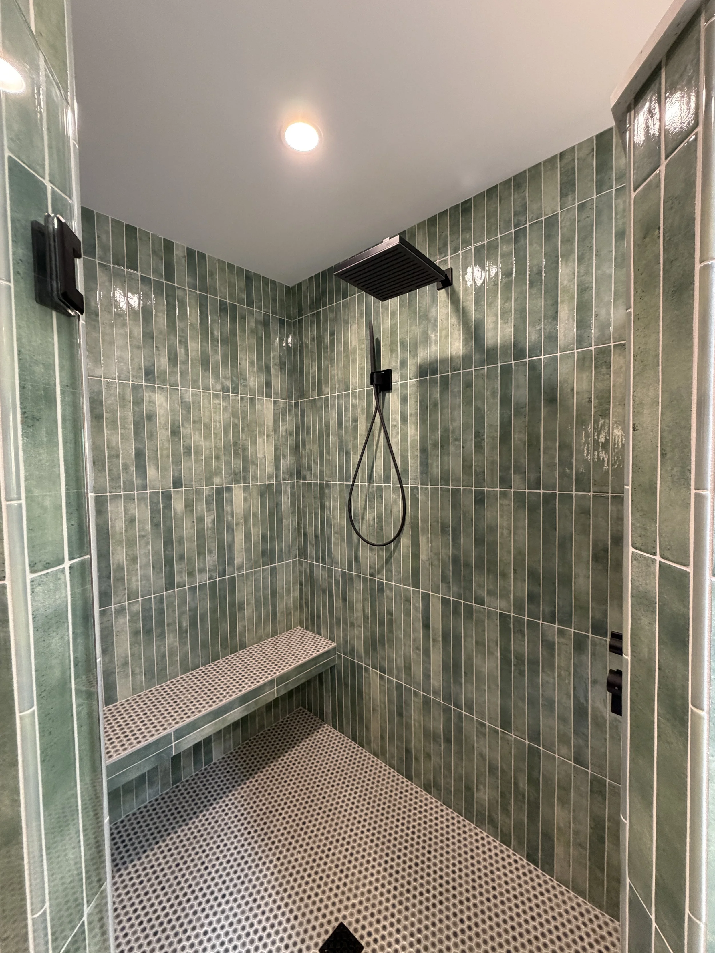 Primary Bathroom Shower with Floating Bench and Matte Black Hardware