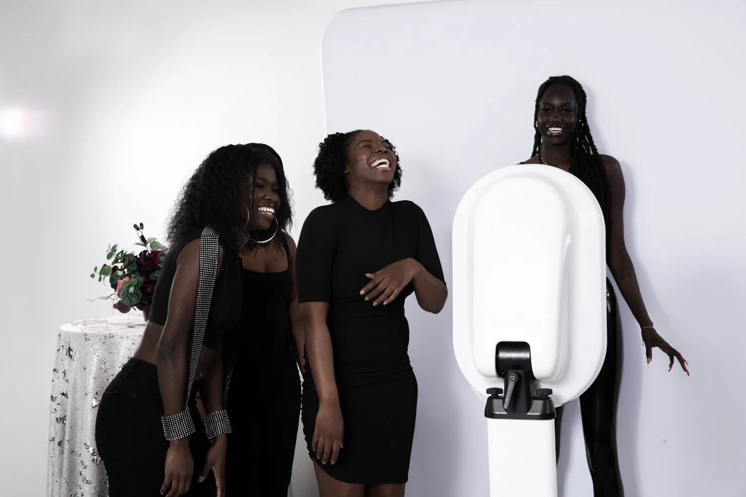 Group of friends enjoying the photobooth experience at an event