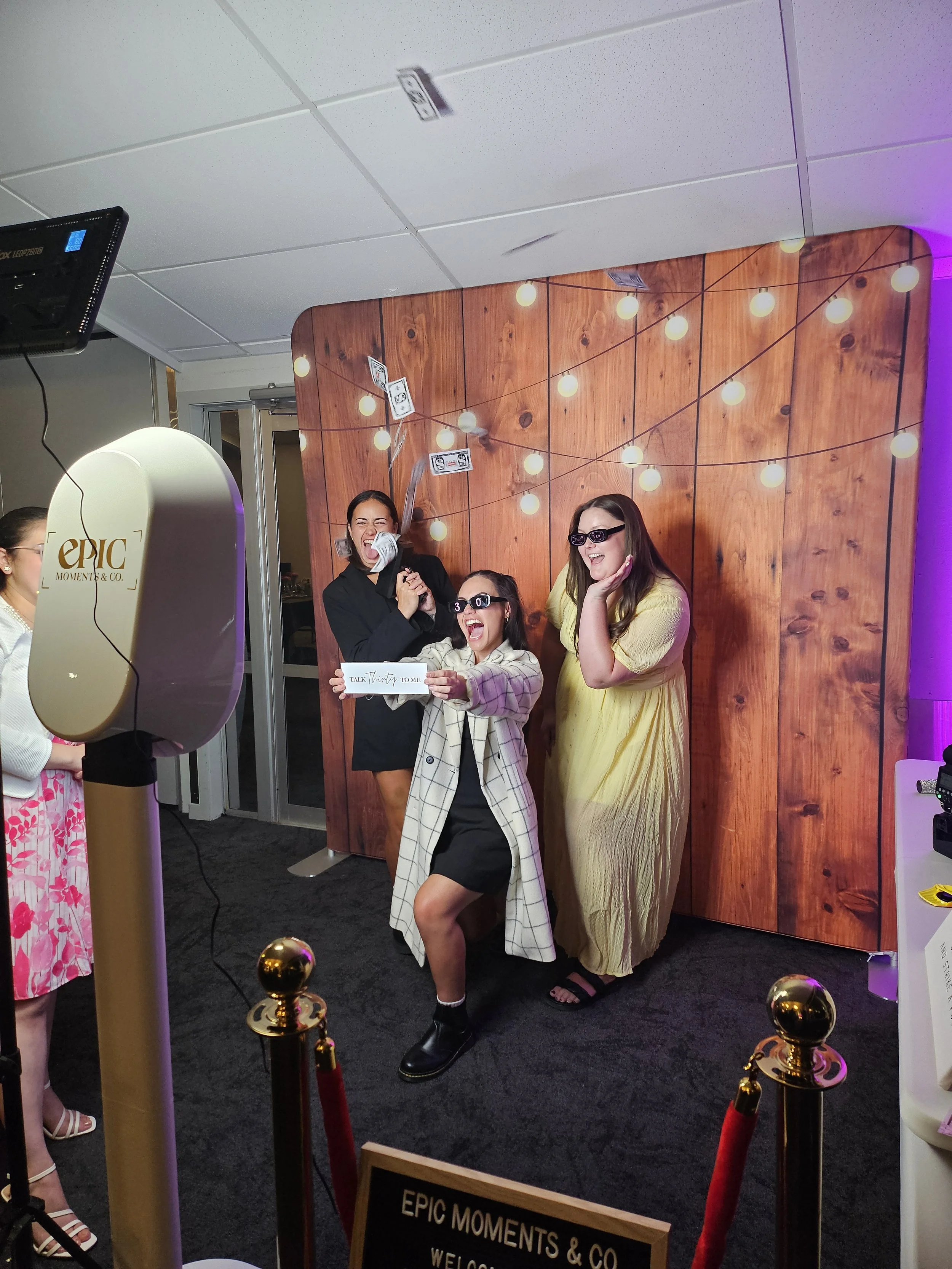 Group of friends enjoying the photobooth experience at an event