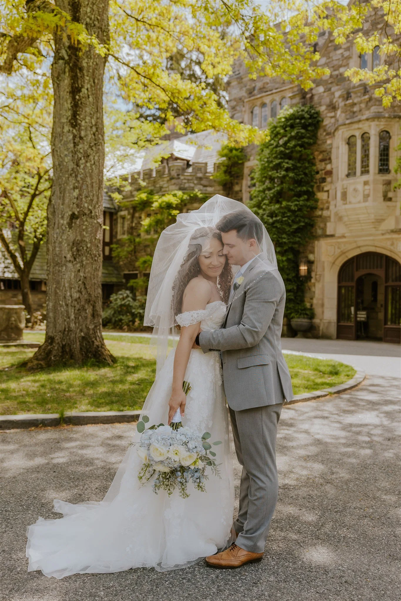 A bride and groom embrace each other at the New Jersey Botanical Gardens