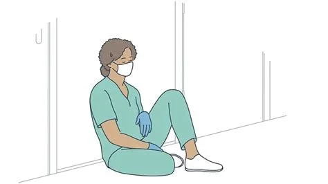 Soignante en tenue médicale assise au sol, épuisée, adossée à un mur