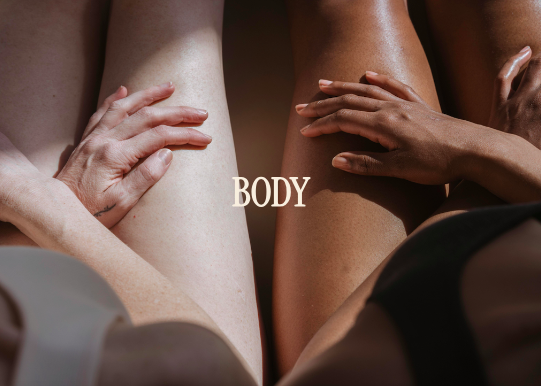Close-up of four hands touching different skin tones on midsection of two bodies, with the word 'BODY' overlayed.
