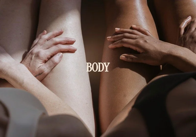 Close-up of multiple human hands resting on thighs of different skin tones against a neutral background with the word 'BODY' in the center.