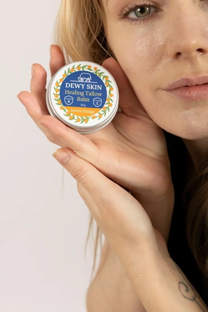 Copy of woman-showing-dewy-skin-healing-tallow-balm-sweet-orange.jpg