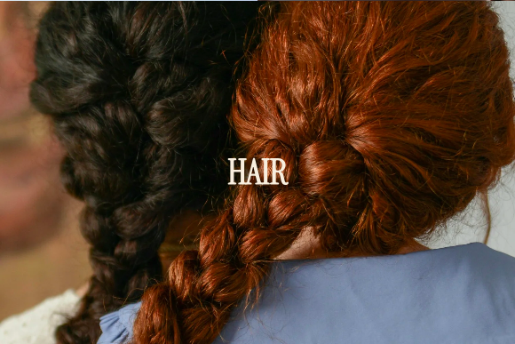 Back view of two women with braided hair, one with dark hair and the other with red hair, with the word 'HAIR' overlayed.