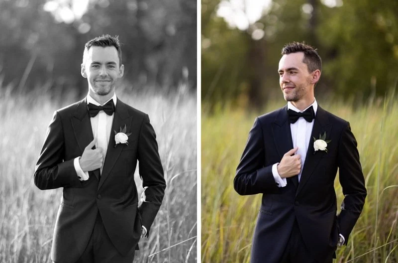 Side-by-side portraits of a groom in a black tuxedo with a white flower boutonniere, standing in a grassy field with trees in the background, one in black and white and one in color.