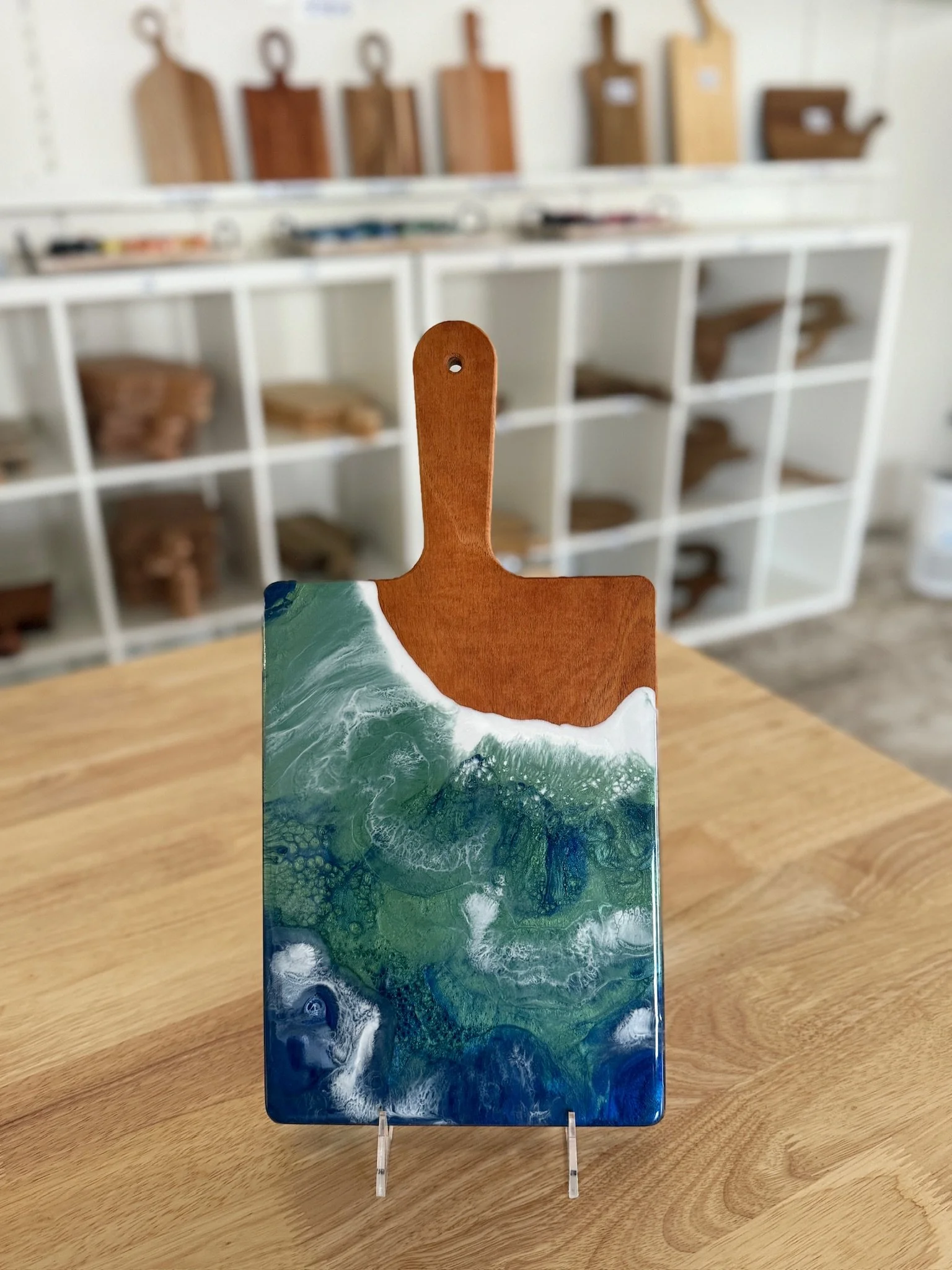 Wooden charcuterie board with resin ocean wave poured on it. 