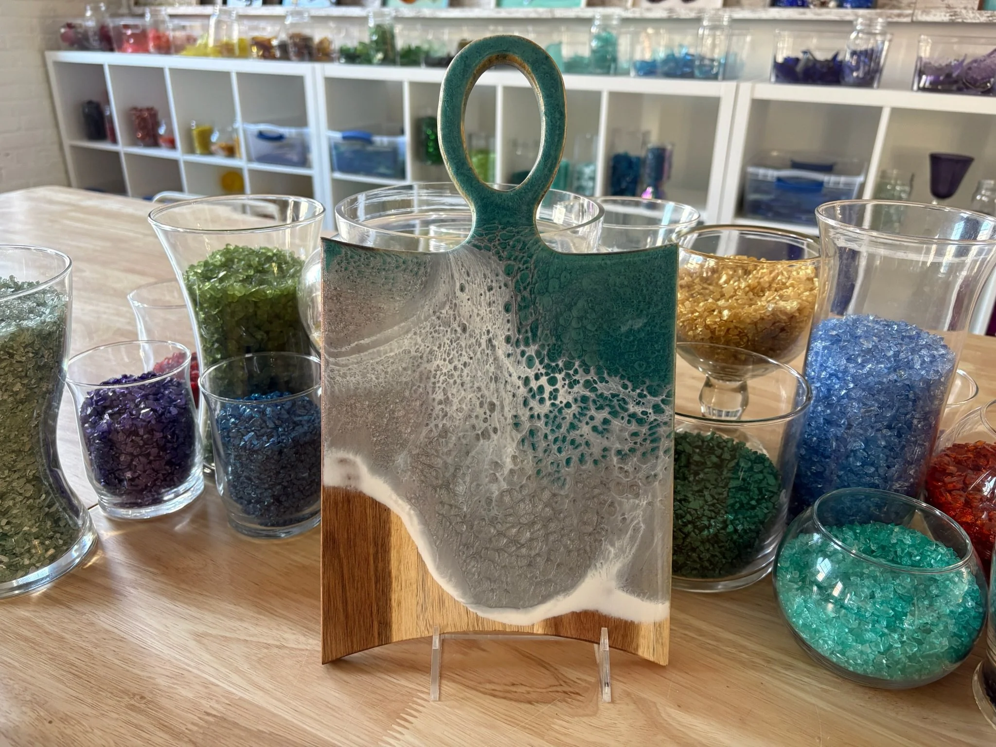 Wooden charcuterie board with resin ocean wave poured on it.