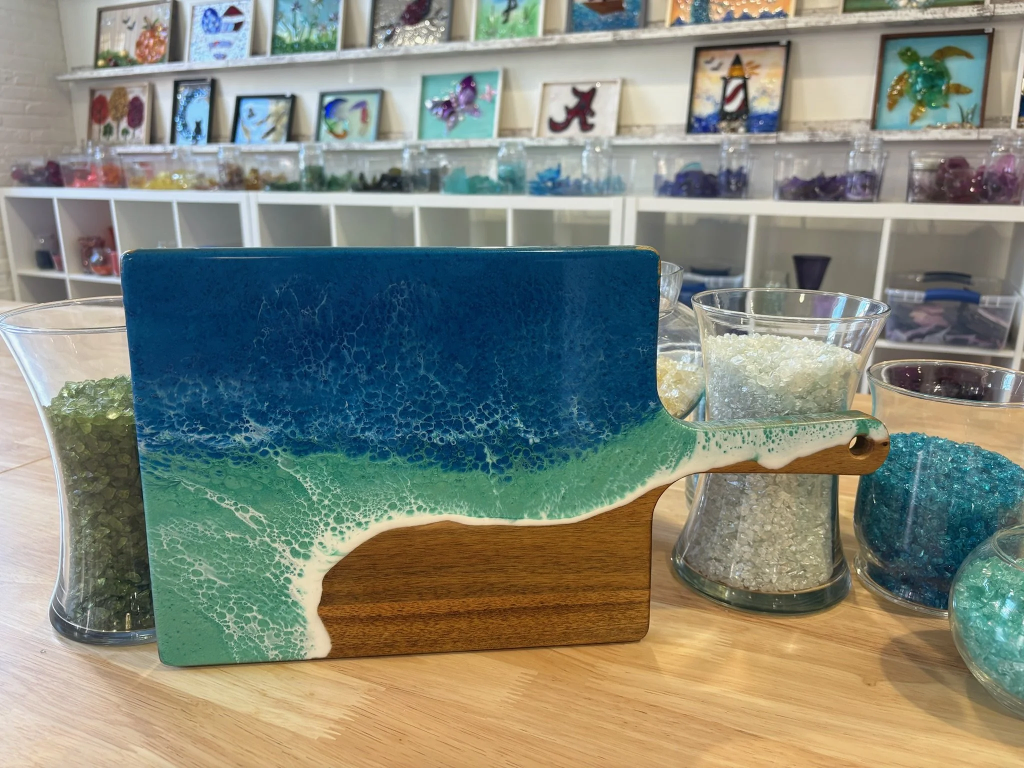 Wooden charcuterie board with resin ocean wave poured on it.