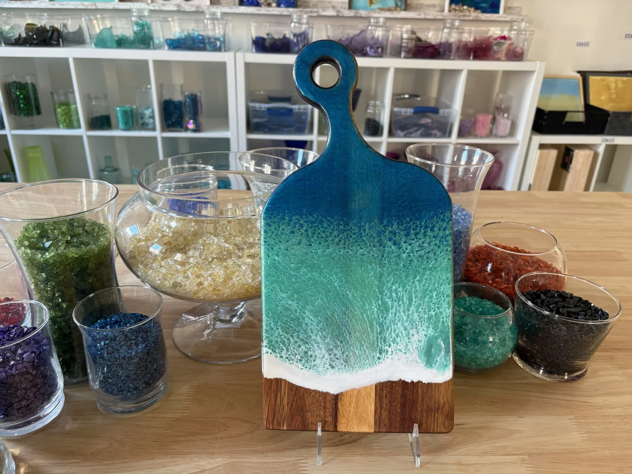 Wooden charcuterie board with resin ocean wave poured on it.
