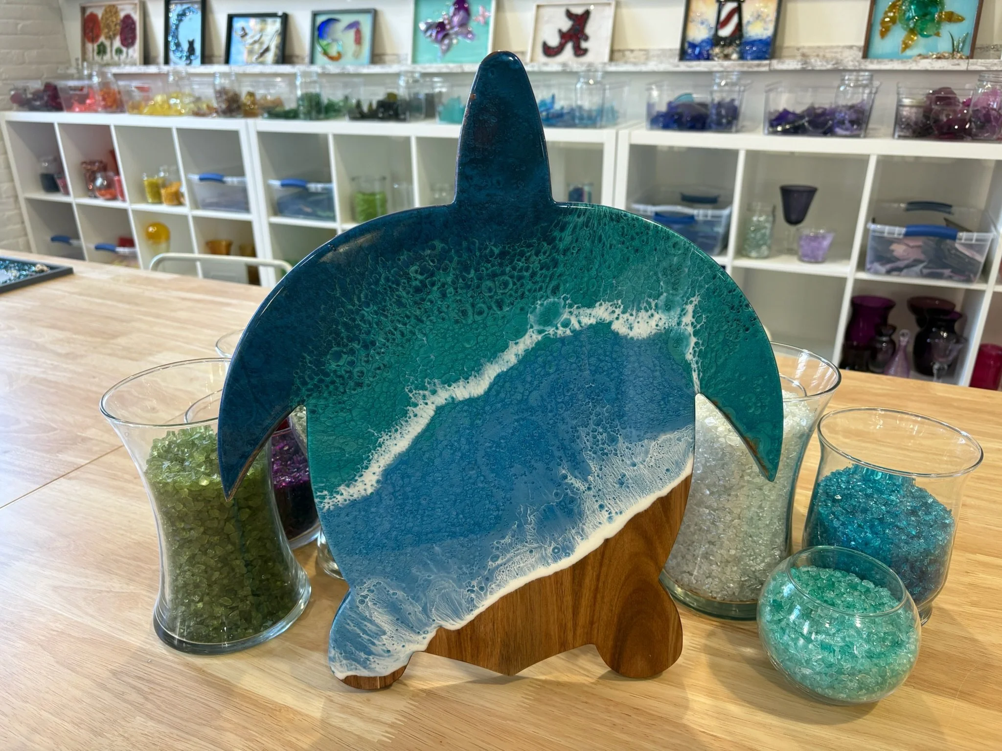 Wooden turtle shaped charcuterie board with resin ocean wave poured on it. 